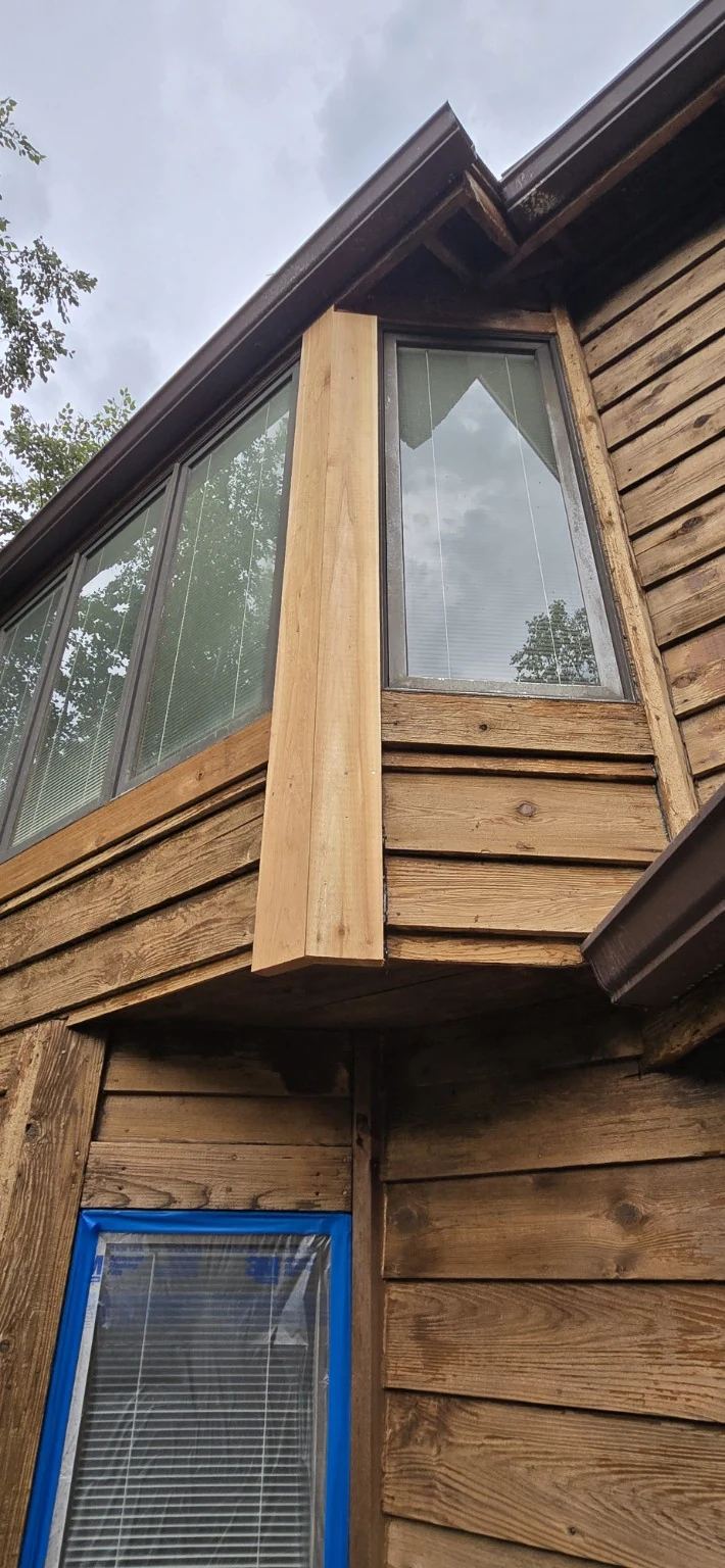 New rough-sawn cedar corner board fitted beside older cedar siding