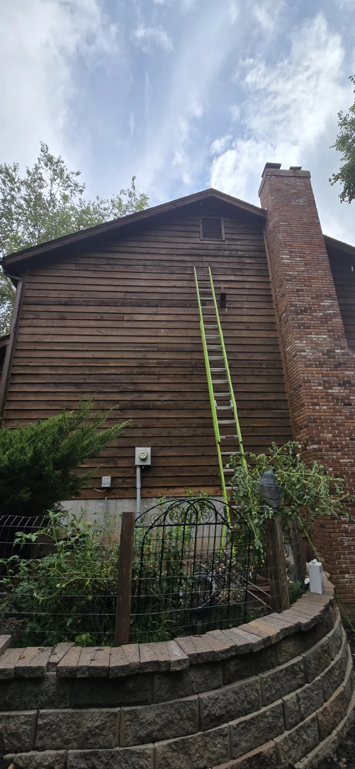 Freshly treated cedar siding while penetrating oil is still dark and glossy