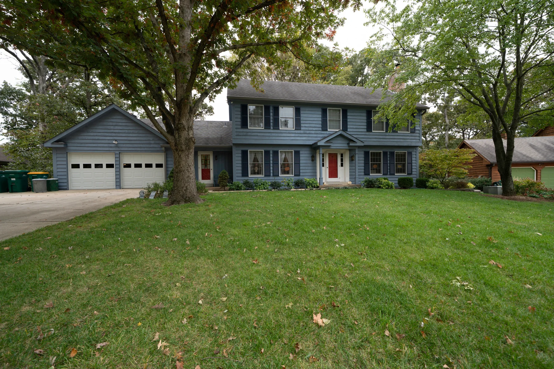 Cedar-sided home with solid color finish and painted shutters