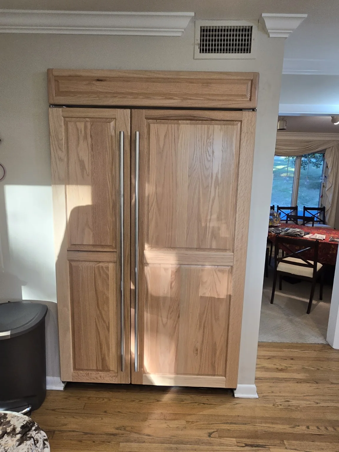Finished natural oak raised panels installed on the Sub-Zero refrigerator