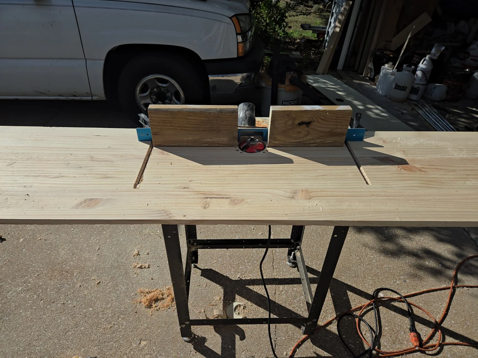 Pine door mockup repurposed as an oversized router table for a large raised-panel bit