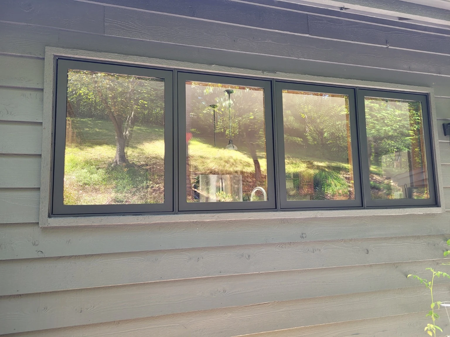 Finished black aluminum window frames after spray refinishing