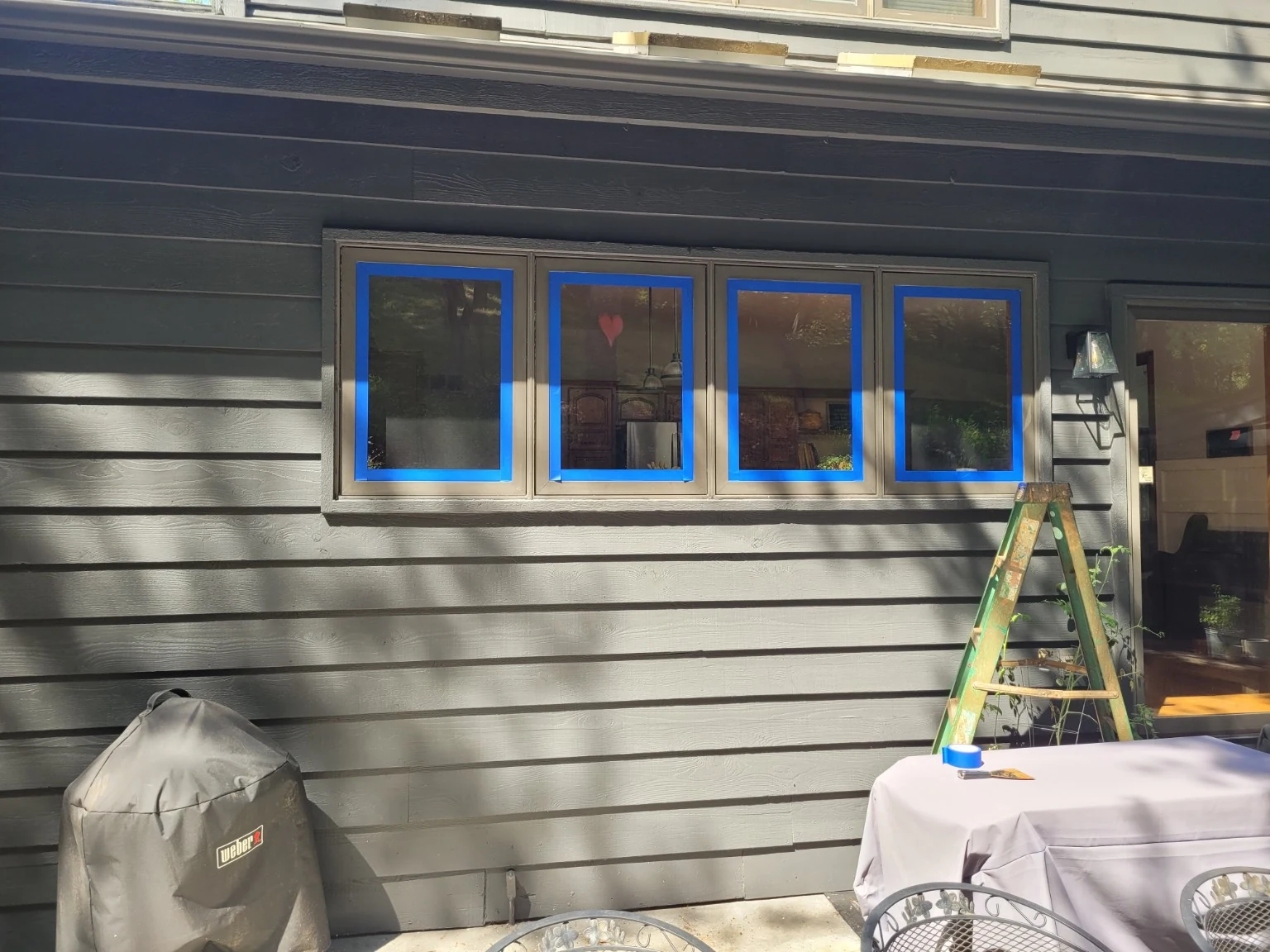 Original brown aluminum window frames before refinishing